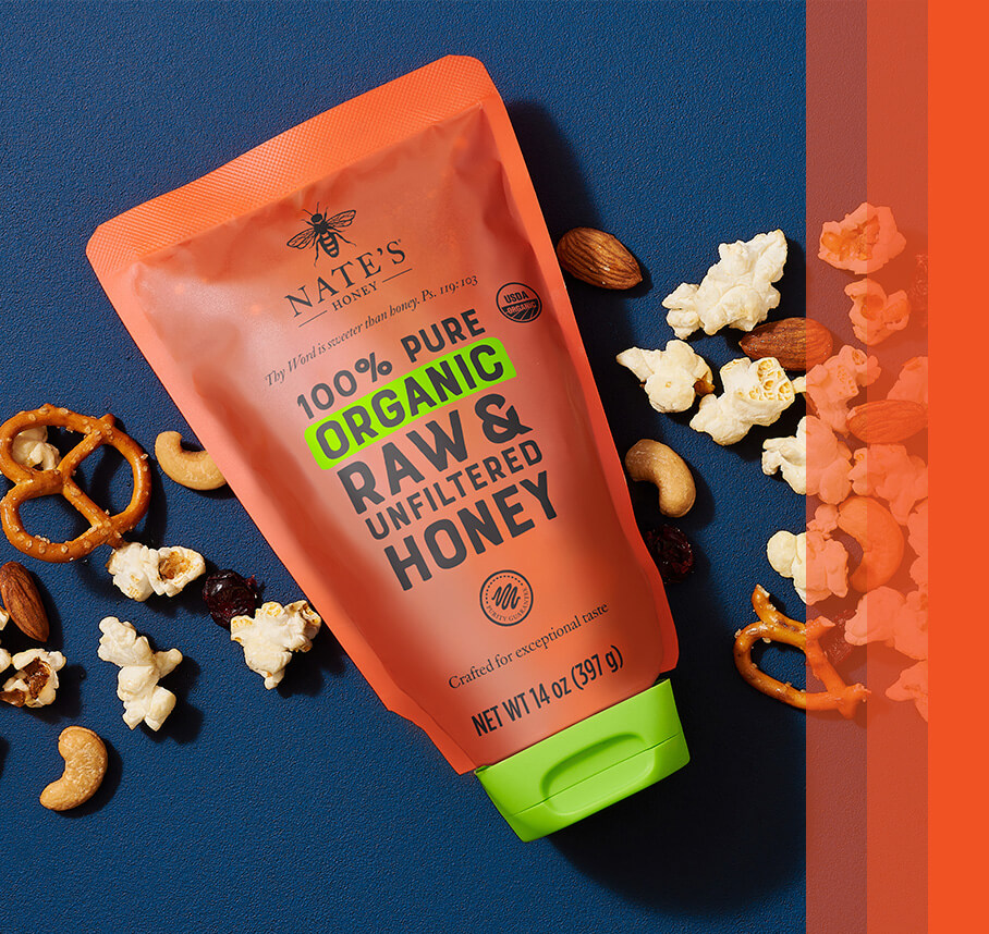 Nate's organic pouch on a blue background with pretzels and popcorn in the scene.