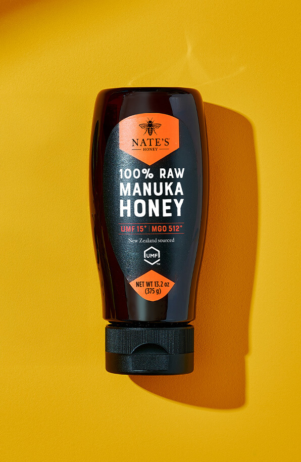Nate's New Zealand Manuka honey bottle centered on a yellow background.