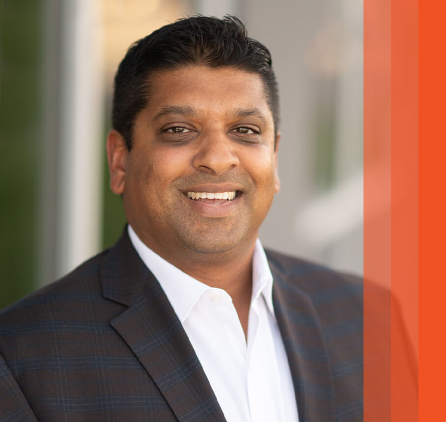 Prashanth headshot with orange bars.