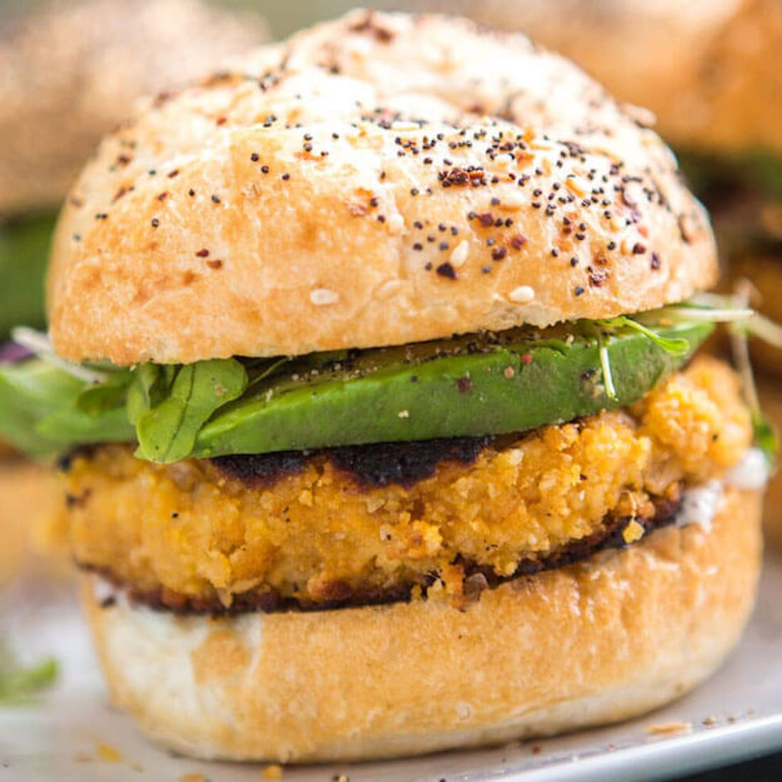 Veggie burger with avocado and sesame bun.
