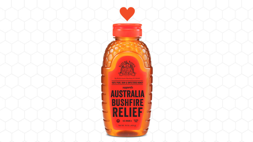 Nate's honey bottle labeled Australia Bushfire Relief with a heart above on a hexagon pattern background.