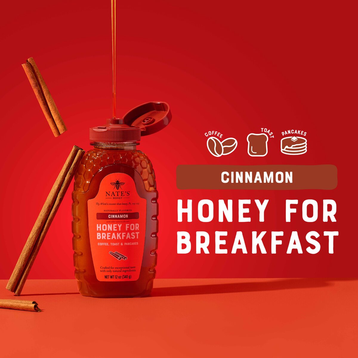 Nate’s Cinnamon Honey bottle with cinnamon sticks and honey drizzle on a red background.