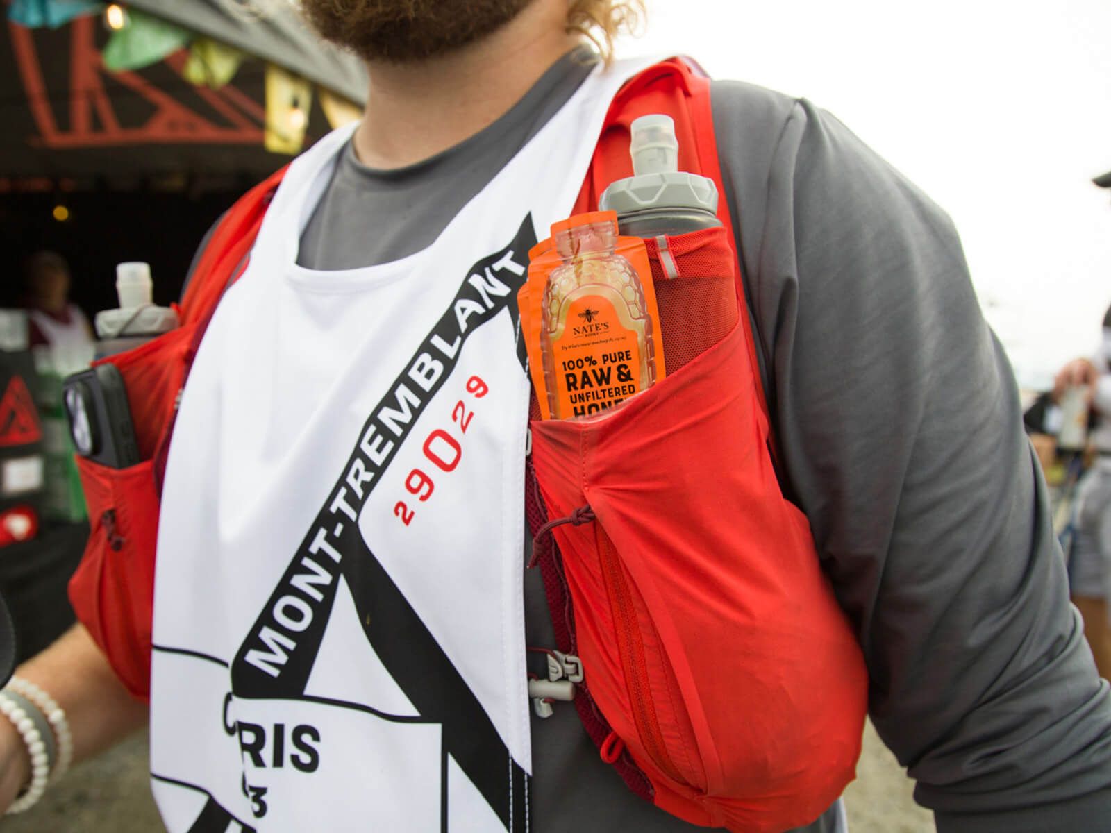 Runner at 29029 Everesting event carrying Nate’s Honey Minis in a red vest pocket alongside a hydration bottle