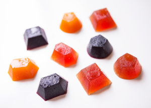 Assorted colorful gummy candies on a white background.