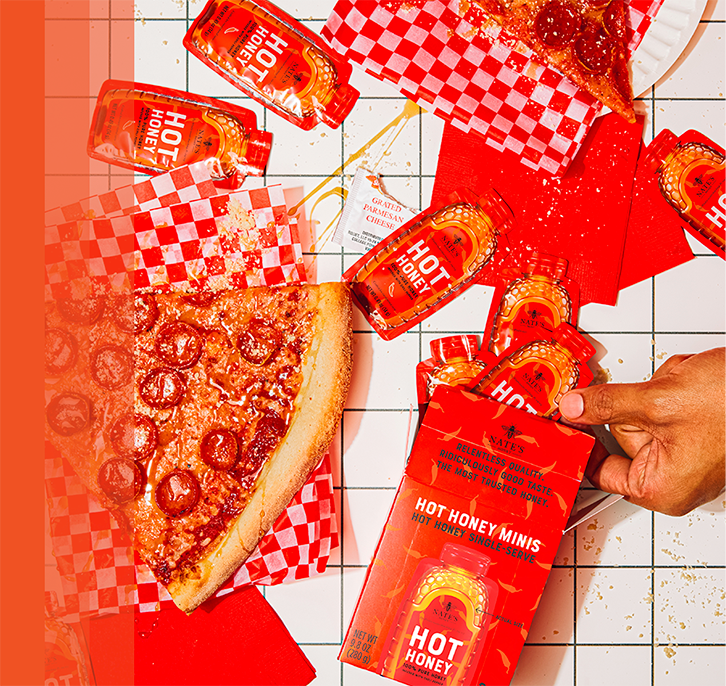 Pizza drizzled with hot honey next to hot honey minis.