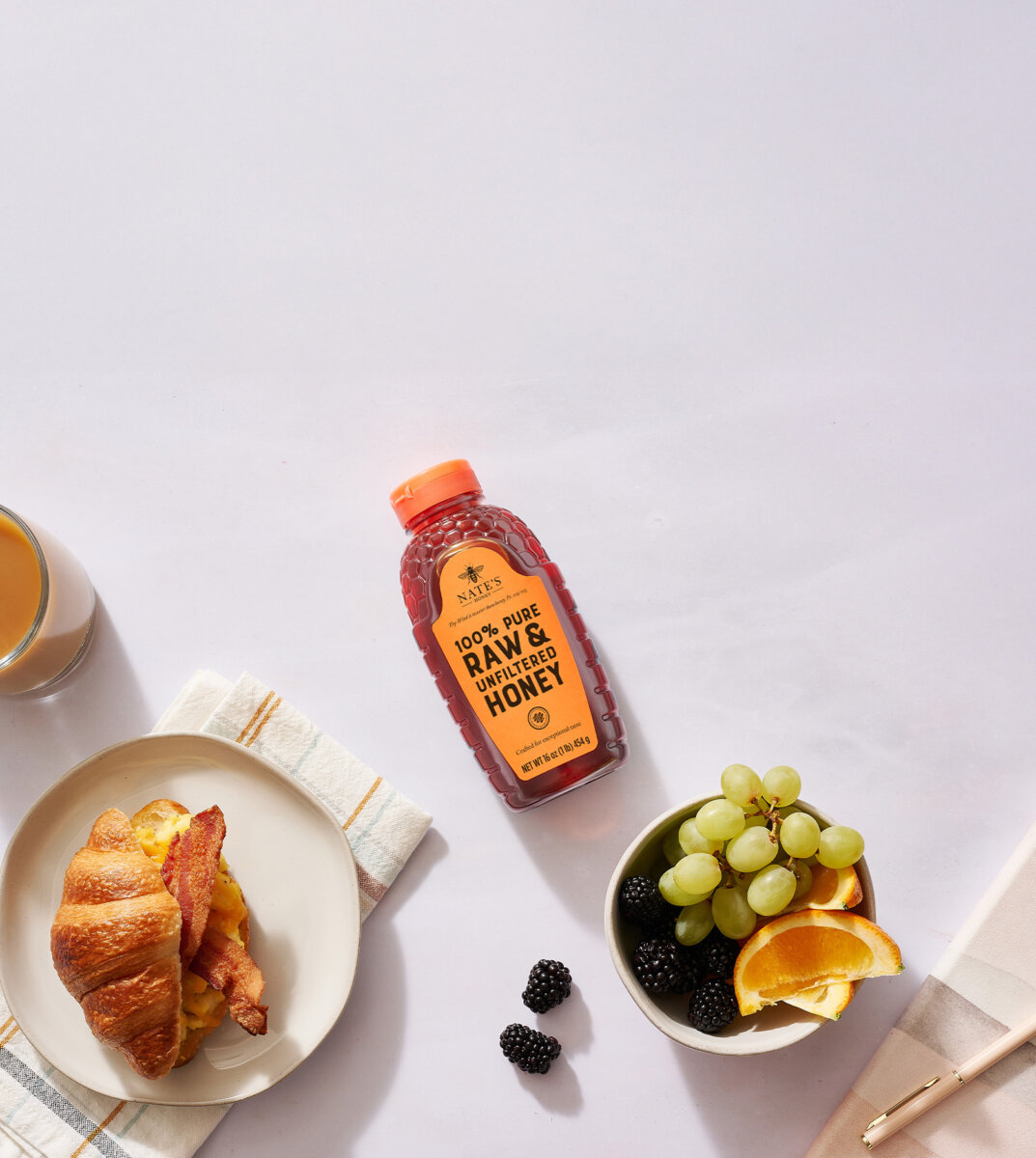 Breakfast table setup with a bottle of Nate’s honey with, IN THE NEWS text overlay.