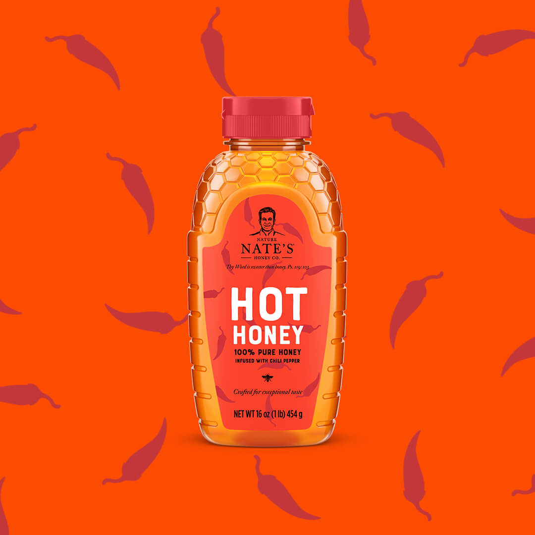 Bottle of Nate's hot honey on orange background with pepper icons