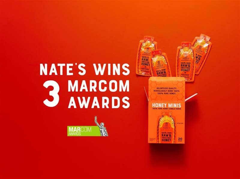 Nate’s honey minis and honey minis box on orange background with MarCom logo awards logo and overtext NATE’S WINS 3 MARCOM AWARDS.