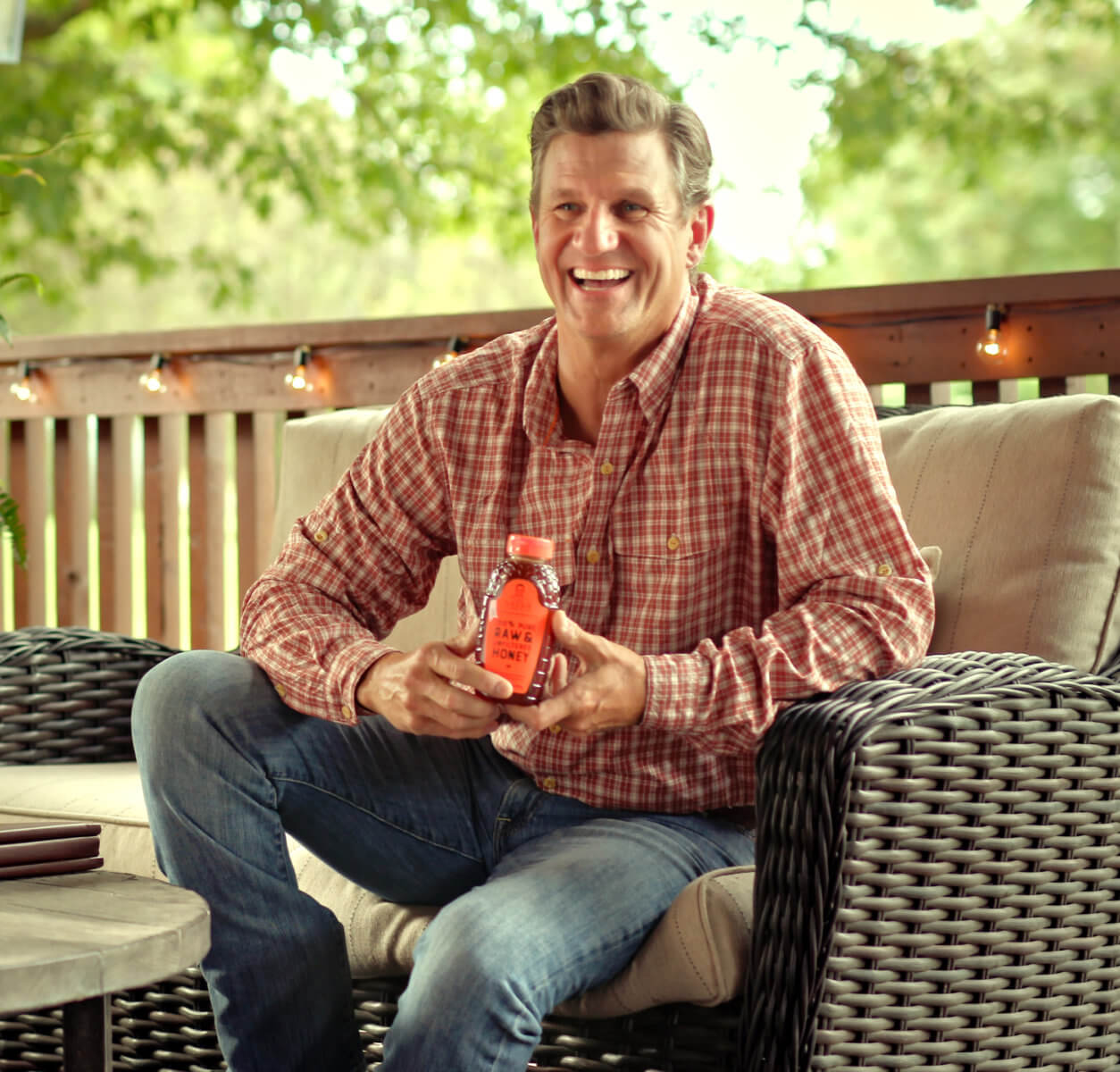 Nathan Sheets on Front Porch with the bottle of honey