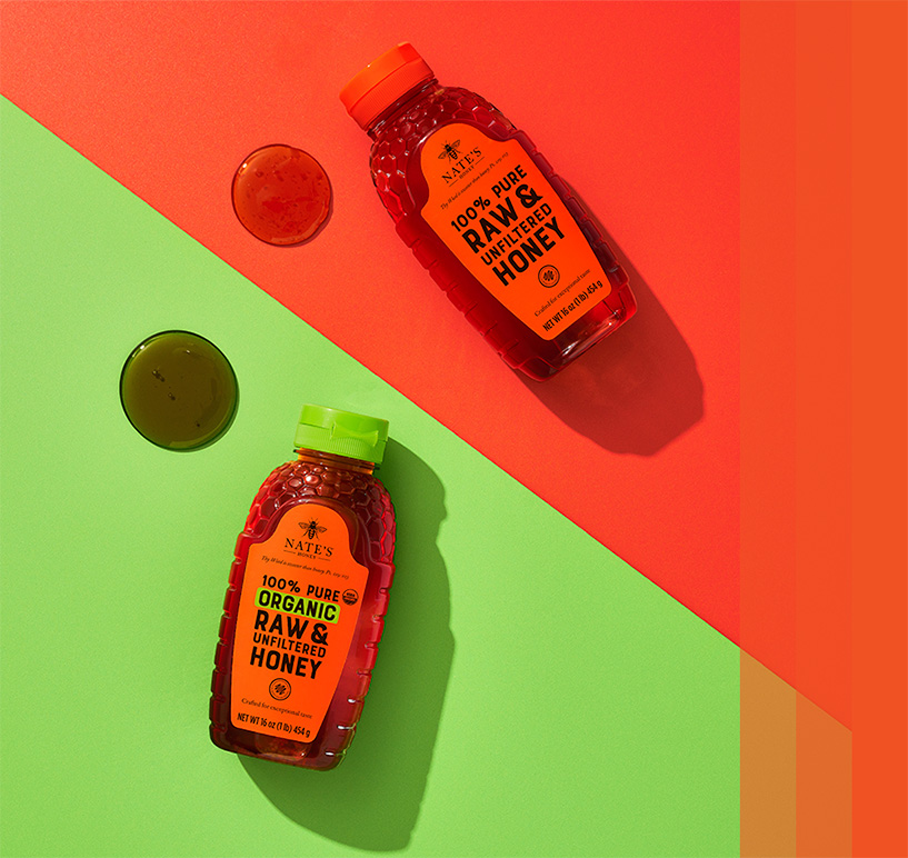 Nate's Classic and Organic Honey bottles on display on green and orange backdrops.
