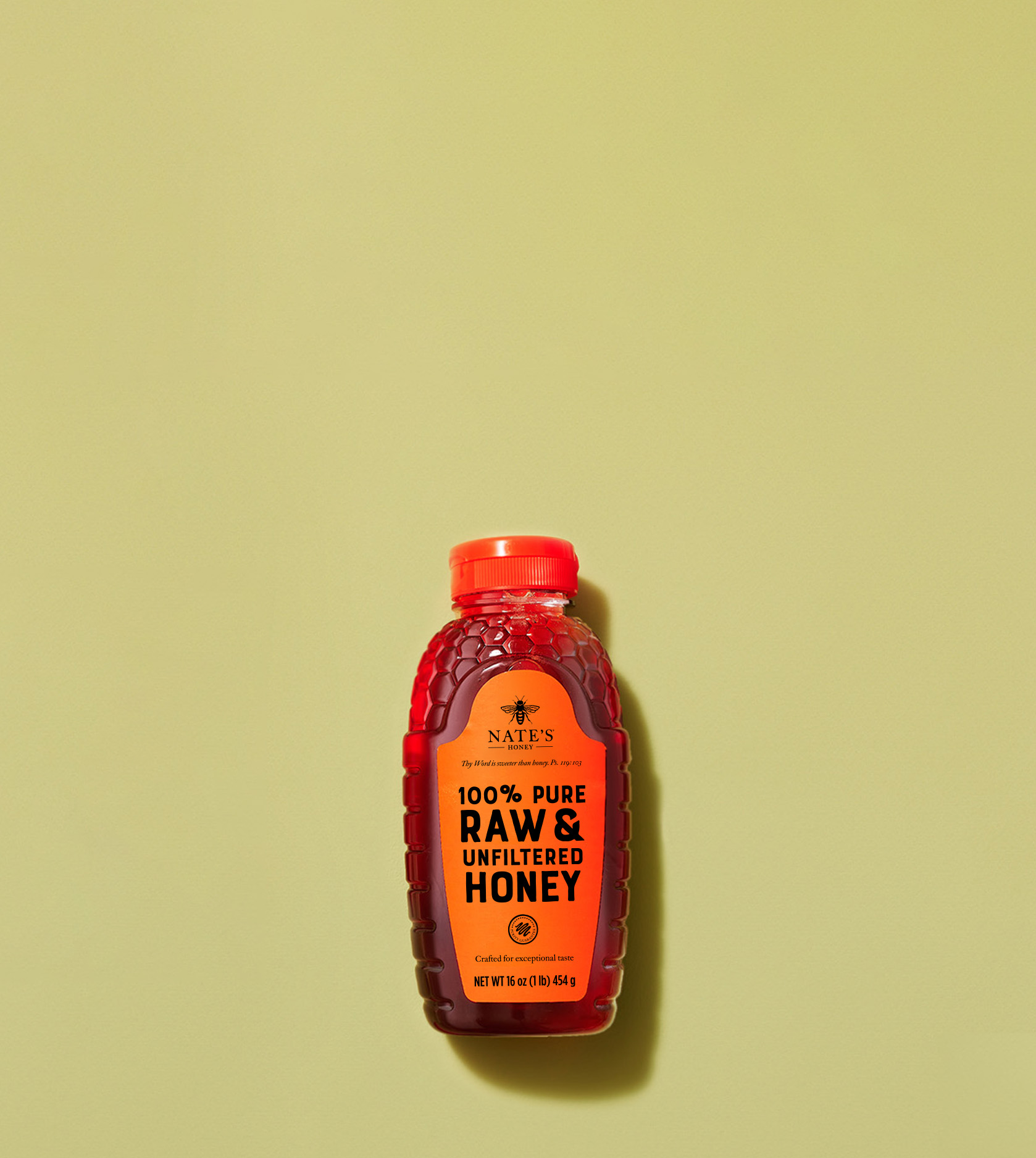 Bottle of Nate's 100% Pure Raw & Unfiltered Honey on yellow background.