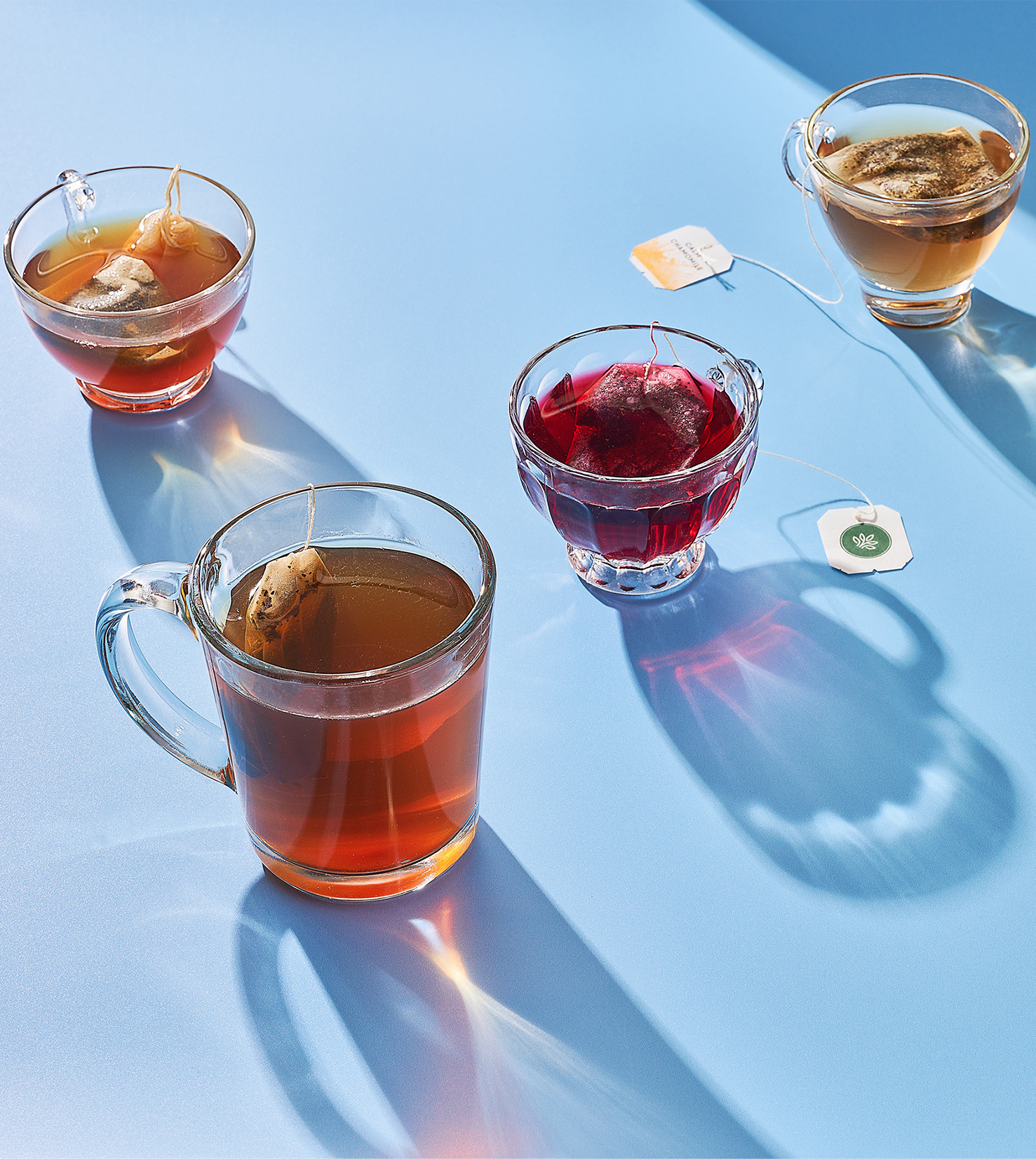 Mugs of tea on blue table.