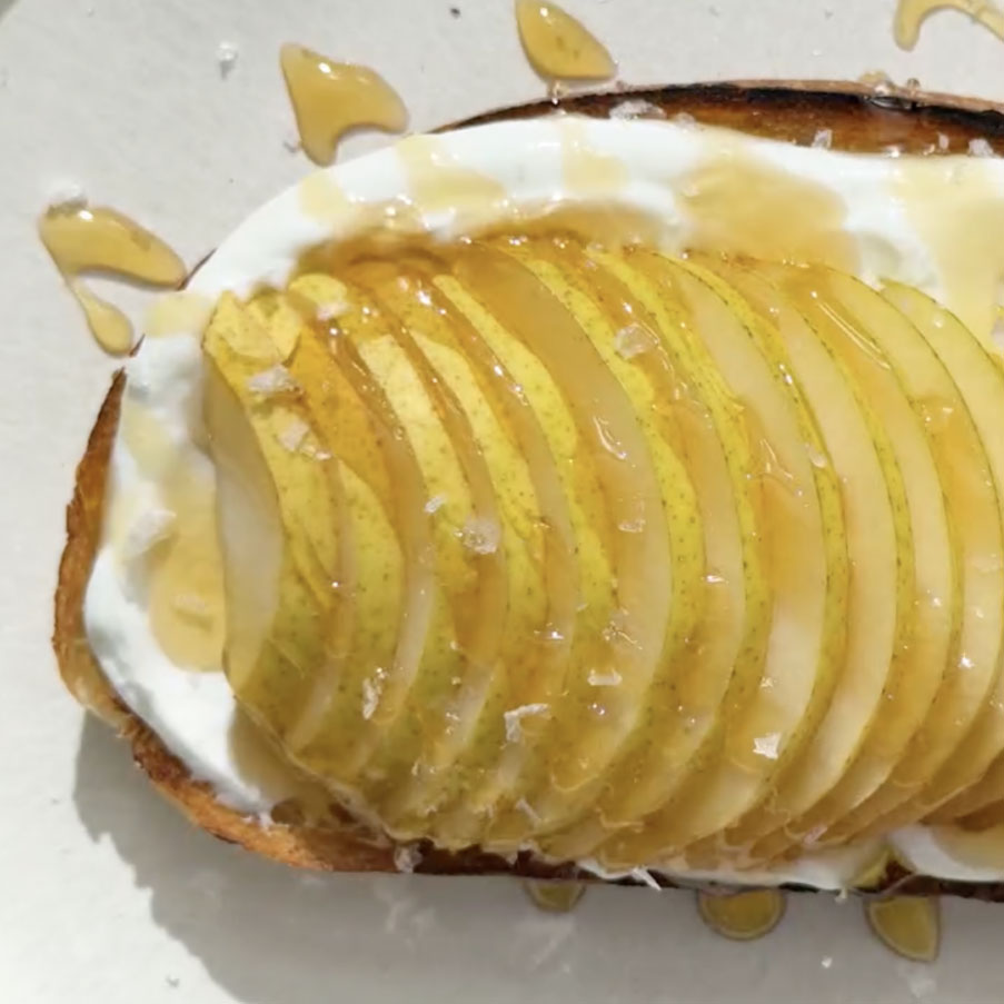 sliced pears on breakfast toast drizzled with honey