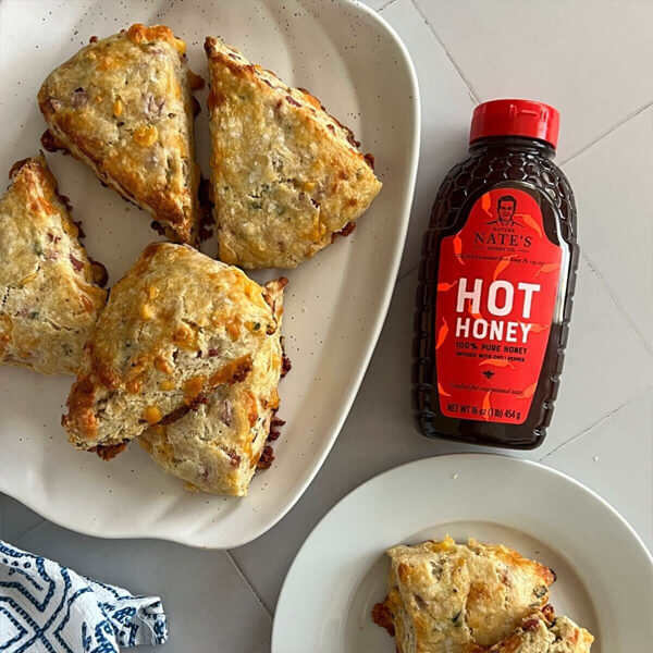 Hot Honey Scones served with Nate's Hot Honey bottle on the side.